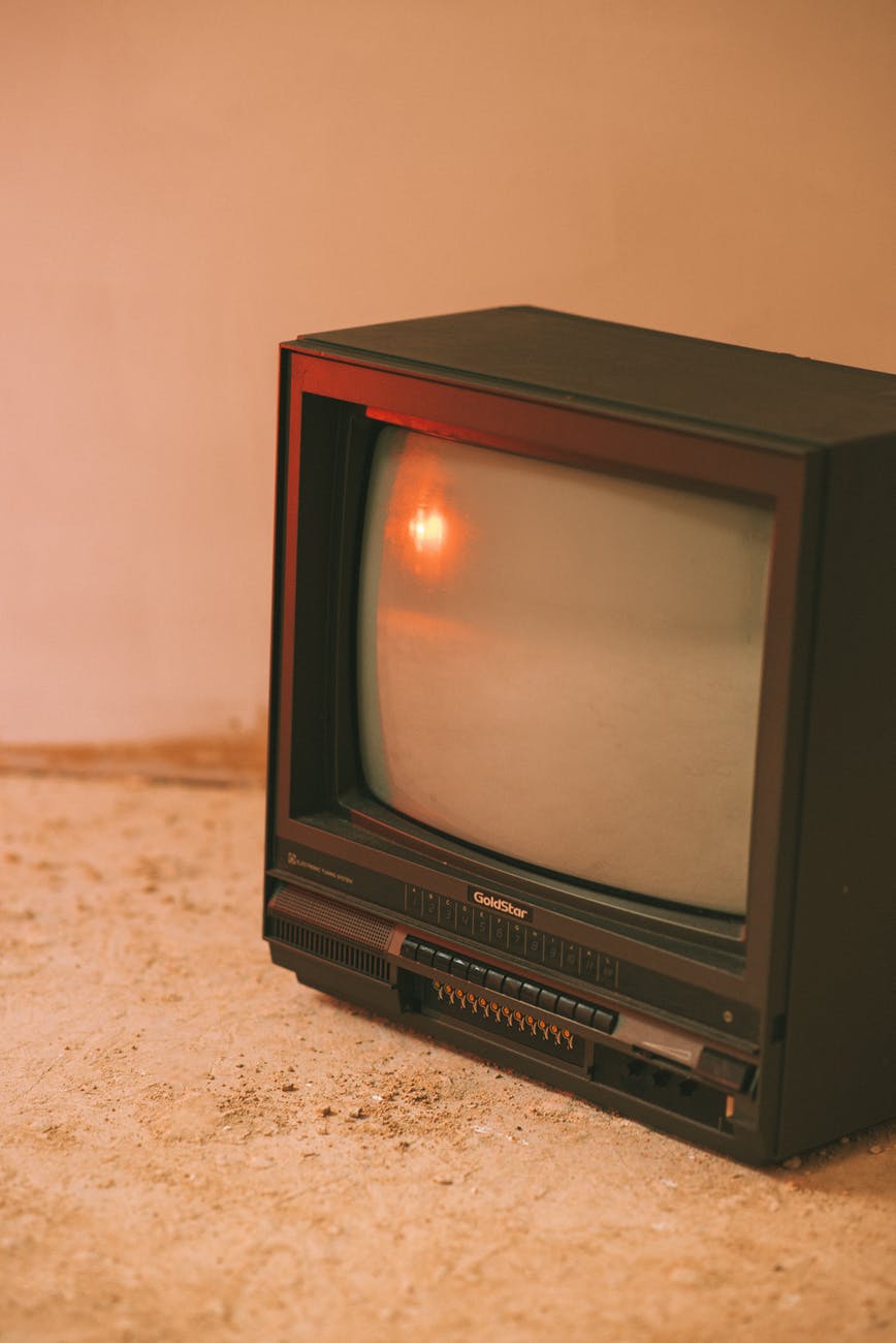 vintage tv set reflecting lamp in building